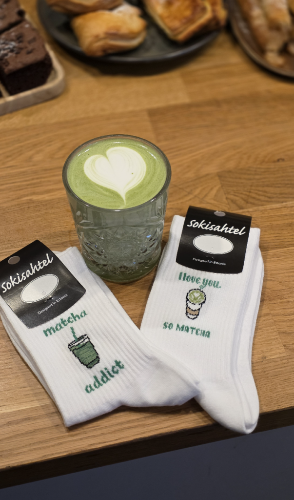 Matcha latte and original matcha socks on a table