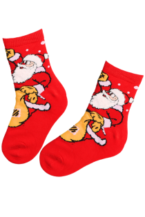 Red children's socks with a Santa Claus pattern, carrying bags. The socks reach the ankle and look comfortable.