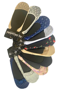 Assortment of multicolored indoor slippers with sock uppers, featuring various patterns and elasticated tops.
