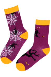 Purple Halloween-themed socks featuring spider webs and witches, with yellow heels and toes.