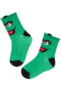 Green cotton socks for children with a black heel and toe area and a colorful monster face design.