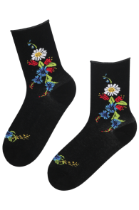 Black cotton socks featuring colorful floral and insect patterns. They are mid-calf in length.