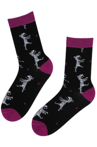 Black Halloween-themed socks with mummies pattern. Features purple toes, heels, and a purple cuff at the top.