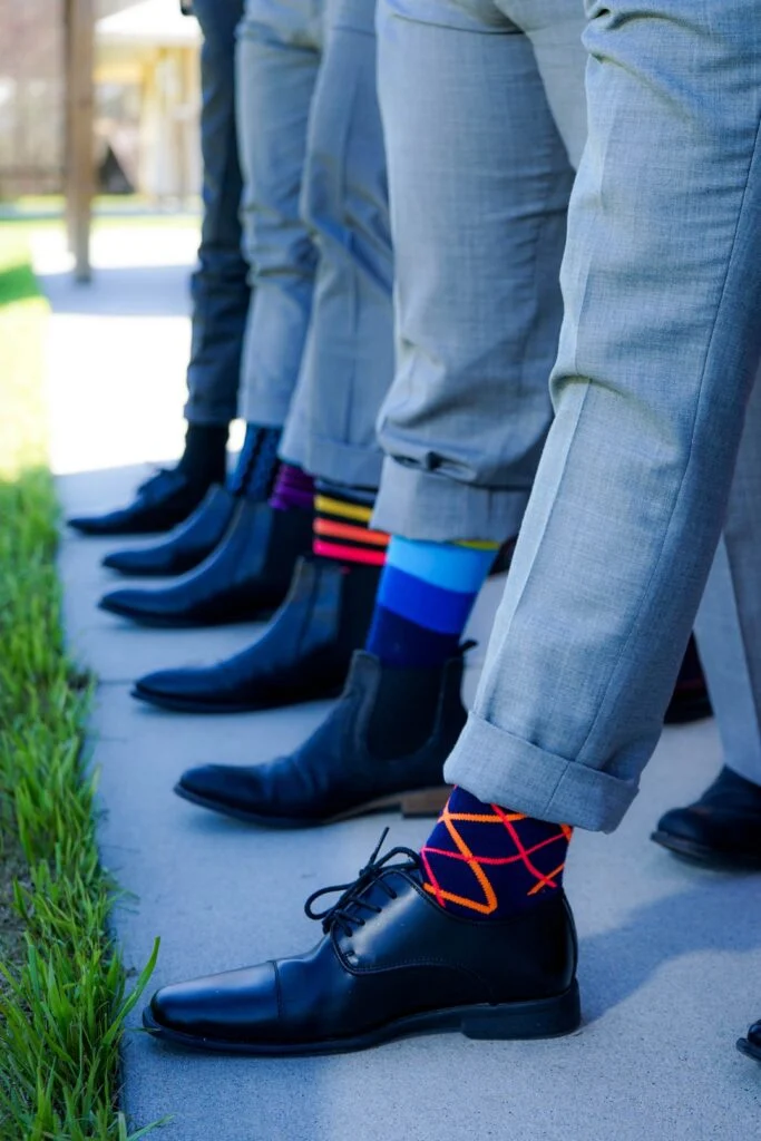 Groomsmen showing off their fun socks