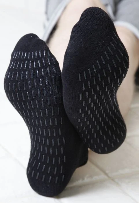 Close-up of black grip socks with non-slip sole grips for Pilates, yoga, and barre.